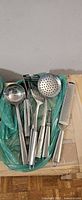 All nine stainless steel kitchen utensils grouped together