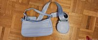 Front of pastel blue shoulder bag, strap, coin pouch, card tag visible