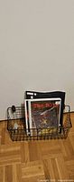 Basket with comics inside against door
