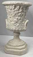 Full view of white concrete urn planter showing overall form