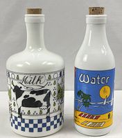Front view of both milk-glass bottles showing labels and stoppers