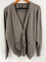 Full front view of cashmere cardigan on hanger