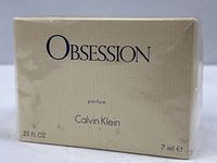 Front of sealed Obsession parfum box showing branding and volume