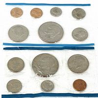 Both coin sets in sealed plastic sleeves