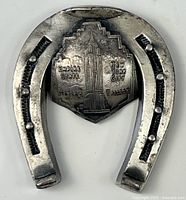 Front view of horseshoe paperweight showing Empire State Building shield and text