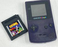 Front view of purple Game Boy Color and Tetris DX cartridge