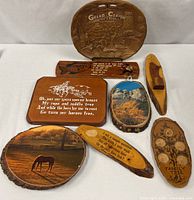 All seven wood plaques and platter displayed together