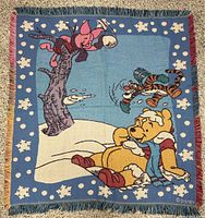 Full view of woven Winnie the Pooh blanket showing entire design and fringe