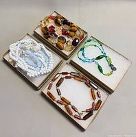 Four necklaces in boxes
