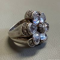 Full view of sterling silver ring showing floral gemstone arrangement