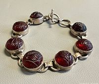 Front view of bracelet showing carved stones and links
