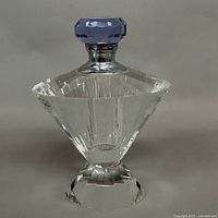 Front view of faceted crystal perfume bottle with blue stopper assembled
