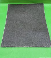 Stack of dark grey emery cloth sheets