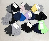 All 20 pairs of assorted knit gloves laid out by color