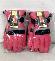 Front view of two packaged pairs of gloves showing brand tags and reflective bands