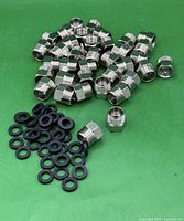 Pile of adapters and washers displayed on green background