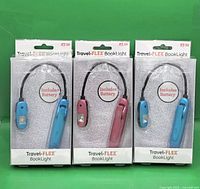 Front view of all three sealed Travel-FLEX BookLights in packaging