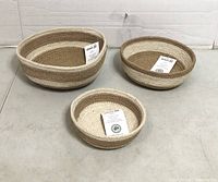Set of three Alkaso jute baskets with tags displayed