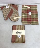 overview of oven mitts, folded apron, packaged table linens