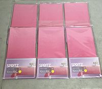 Six Spritz ombre pink table covers in original packaging