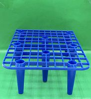 Top view of blue plastic lattice grid on legs