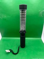 Full upright view showing side LED array and wrist strap
