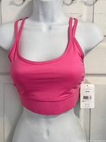 Front view of pink Athletic Works sports bra on mannequin with tag