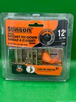 Front view of packaged Stinson 12 ft endless ratchet tie-down strap