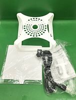 Trap components in plastic bags: base, glue board, cord, instructions