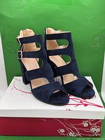 Front angled view of both sandals showing open toe, block heel, and strappy design