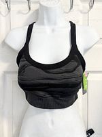 Front view of black camo Athletic Works strappy sports bra on mannequin