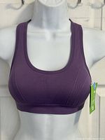 Front view of purple racerback sports bra on mannequin