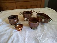 All five copper pieces displayed on table