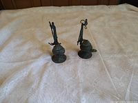 Both bronze oil lamps front view on table