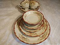 Stacked plates and bowls showing pattern and trim