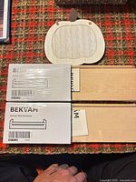 Two boxed BEKVÄM spice racks and wooden apple décor piece