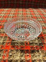Side view of clear pressed glass Wexford bowl showing scalloped rim and pattern