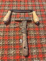 Both tools laid out: cooper’s hammer and curved drawknife