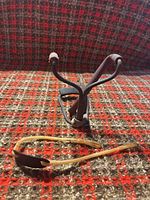 Front view of steel frame wrist-brace slingshot and detached latex band