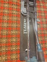 Full view of tile cutter showing rails, base and handle