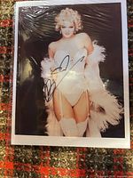 Front view of signed Drew Barrymore photograph in sleeve