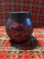 Side view of matte black ceramic fragrance lamp base with red dragon design