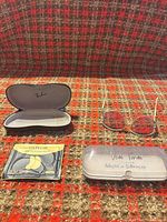 All four items displayed: Ray-Ban case, Giovani sunglasses, Veda Tinda case, 24K eye mask packet