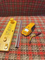 Group shot of all four items: Hang & Level tool, stud finder, straightedge, test light