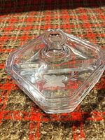 Lid showing etched floral design and knob handle