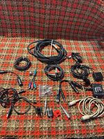 Overview of entire assortment on patterned surface, showing cables, adapters and connectors