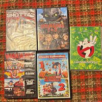 Group shot of all five DVD cases on red patterned surface