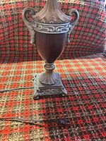 Full view of urn base showing scrolled handles, fluted pedestal and power cord