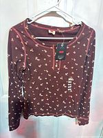 Full view of Levi’s long-sleeve floral Henley top on hanger