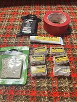 Overview of all items: paracord, tape, glue, bumper pads, six hardware boxes